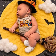 Theodore is registered to the contest to win money with this photo: baby, infant, child, sleeping, halloween, witch_hat, pumpkin, broomstick, costume, yellow_blanket, clouds, stars, bats, portrait, indoor, photography, cute, baby_booties, dark_background, festive