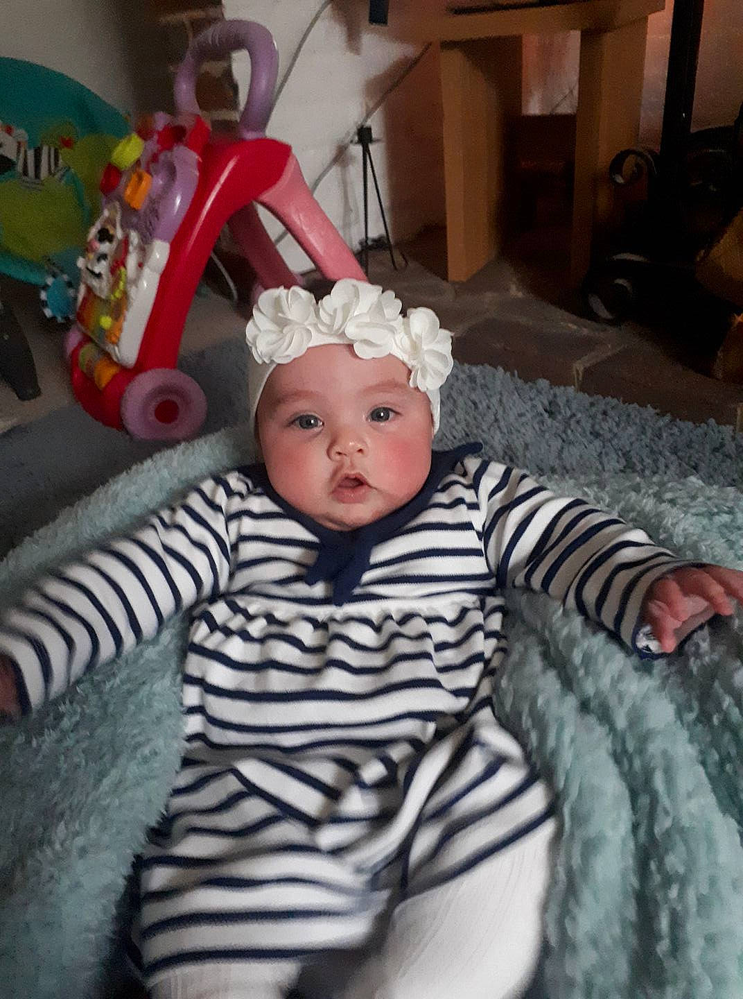 Emily is registered to the contest to win money with this photo: child, day, eye, face, fun, girl, head, headgear, headwear, infant, organ, person, product, skin, textile, toddler