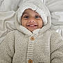 Tayyib joined the competition — help win amazing prizes! baby, blanket, button, buttoned, child, clothing, cozy, cute, face, happy, hood, indoor, infant, knitted_sweater, person, portrait, smile, soft, warm, wearing