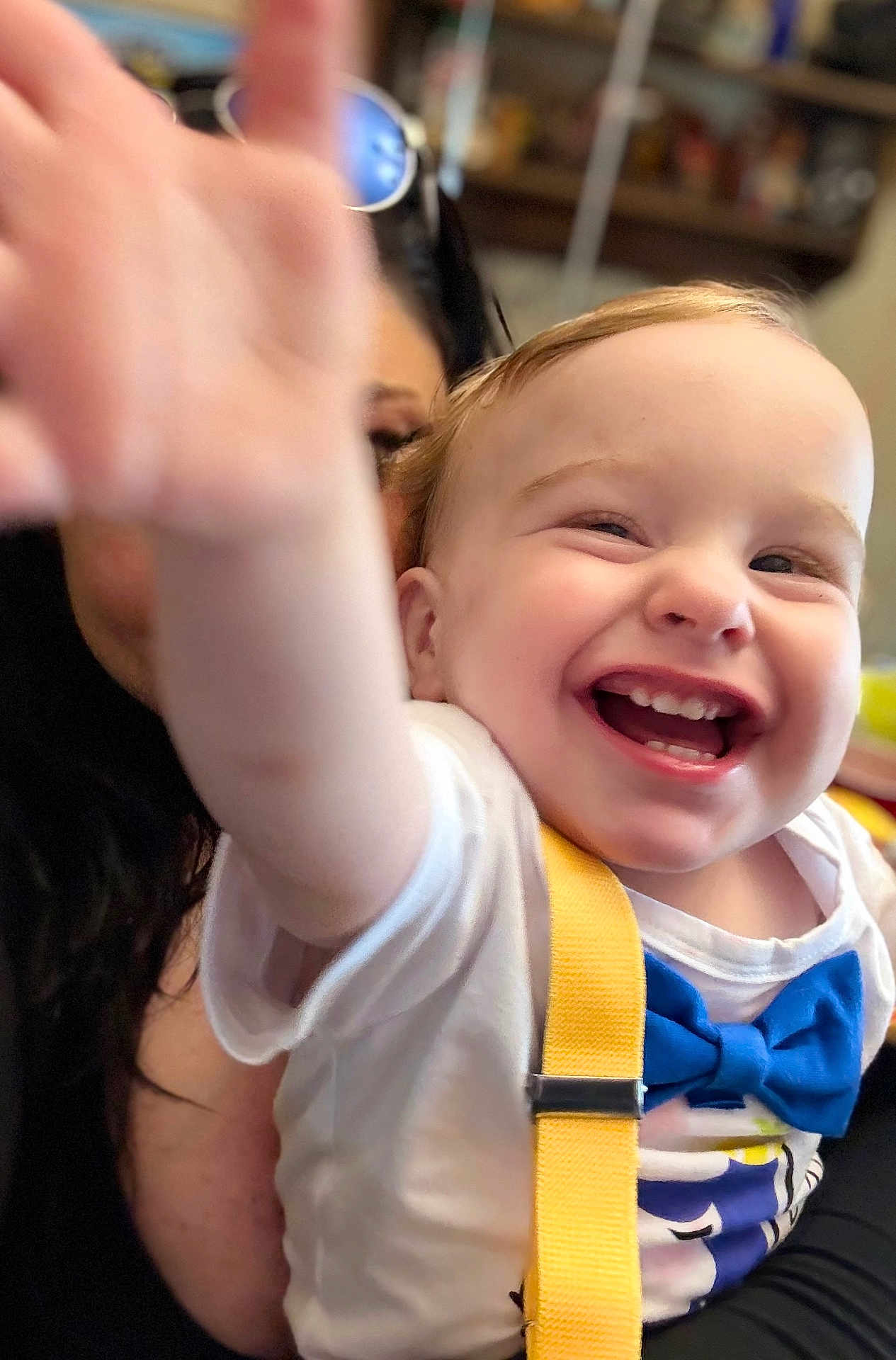 Hunter is registered to the contest to win money with this photo: toddler, child, smiling, happy, face, hand, blue_bow_tie, yellow_suspender, white_shirt, person, indoor, adult, glasses, closeup, joy, baby, cute, expression, portrait, family