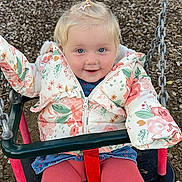 Willow joined the competition — help win amazing prizes! child, toddler, swing, playground, jacket, floral_pattern, pink_tights, blonde_hair, pony_tail, smiling, blue_eyes, outdoor, play, seat, chains, wood_chips, happy, cute, winter_clothing, fun