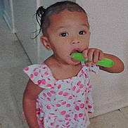 Tru'Melody is registered to the contest to win money with this photo: toddler, child, indoors, barefoot, pink_clothing, popsicle, food, curly_hair, standing, floor, cute, young_child, person, playful, summer_treat, snack, wall, doorway, portrait, casual