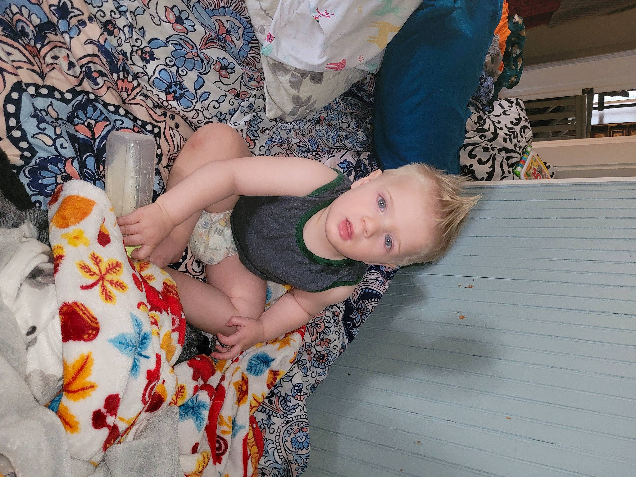 Roman is registered to the contest to win money with this photo: child, comfort, flesh, flooring, foot, fun, happy, human_leg, joint, leg, linens, nap, pattern, person, plant, sitting, thigh, toddler, tree, trunk