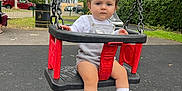 Layla joined the competition — help win amazing prizes! background, chain, child, clothing, daylight, expression, face, greenery, outdoor, park, pavement, person, playground, seat, shoes, socks, swing, toddler, trees, urban
