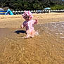 baby, child, beach, water, splashing, swimsuit, sun_hat, sand, sea, waves, outdoor, summer, nature, sky, trees, holiday, vacation, sunny, play, fun