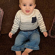 Muhammed joined the competition — help win amazing prizes! toddler, child, baby, sitting, couch, clothing, sweater, denim, pants, barefoot, face, smile, drool, indoor, furniture, young_child, portrait, casual, striped, comfortable