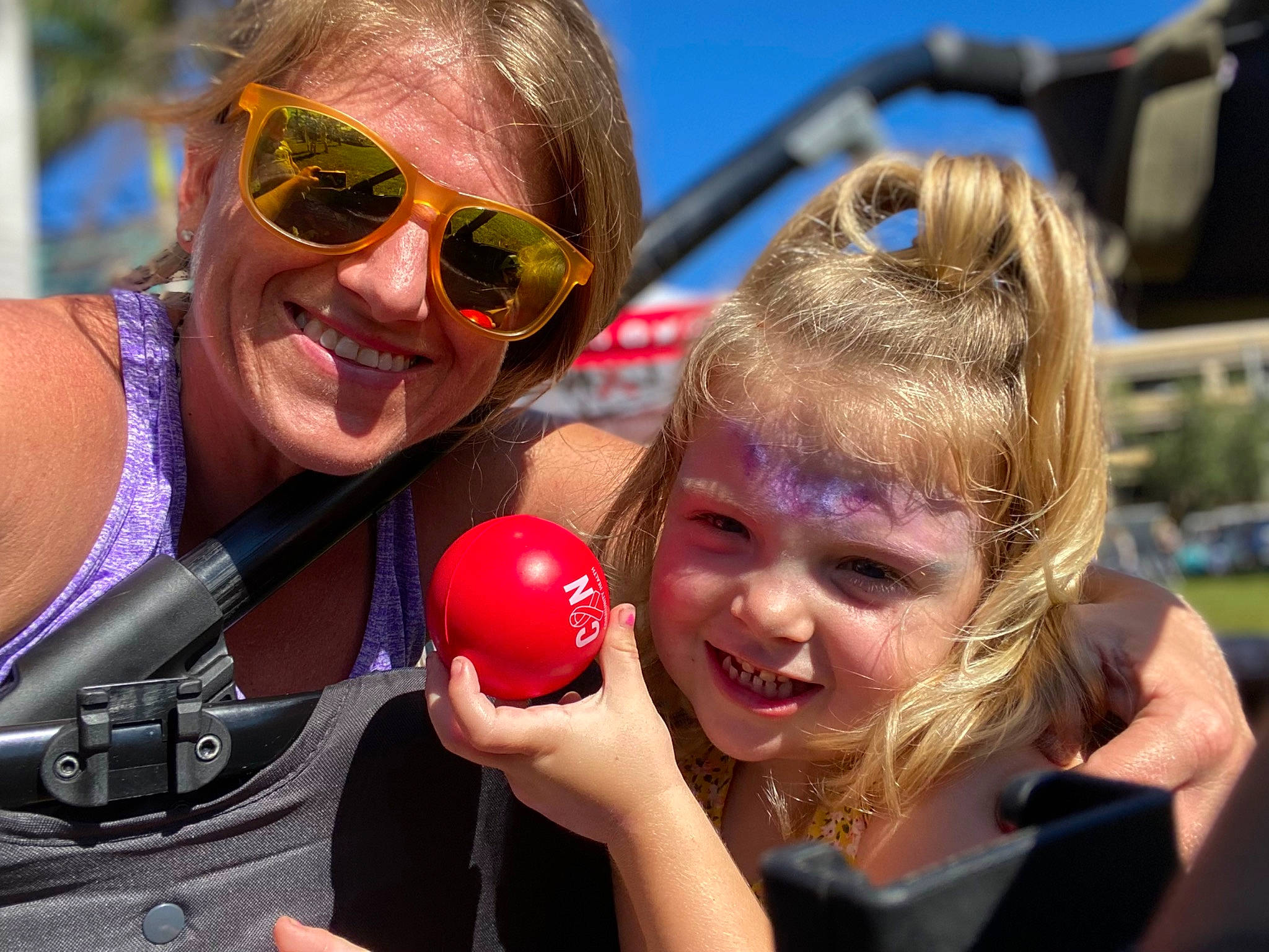 Kyla joined the competition — help win amazing prizes! car, child, event, eyewear, face, facial_expression, fun, gesture, goggles, hand, happy, joy, leisure, motor_vehicle, person, recreation, sky, smile, sunglasses, toddler