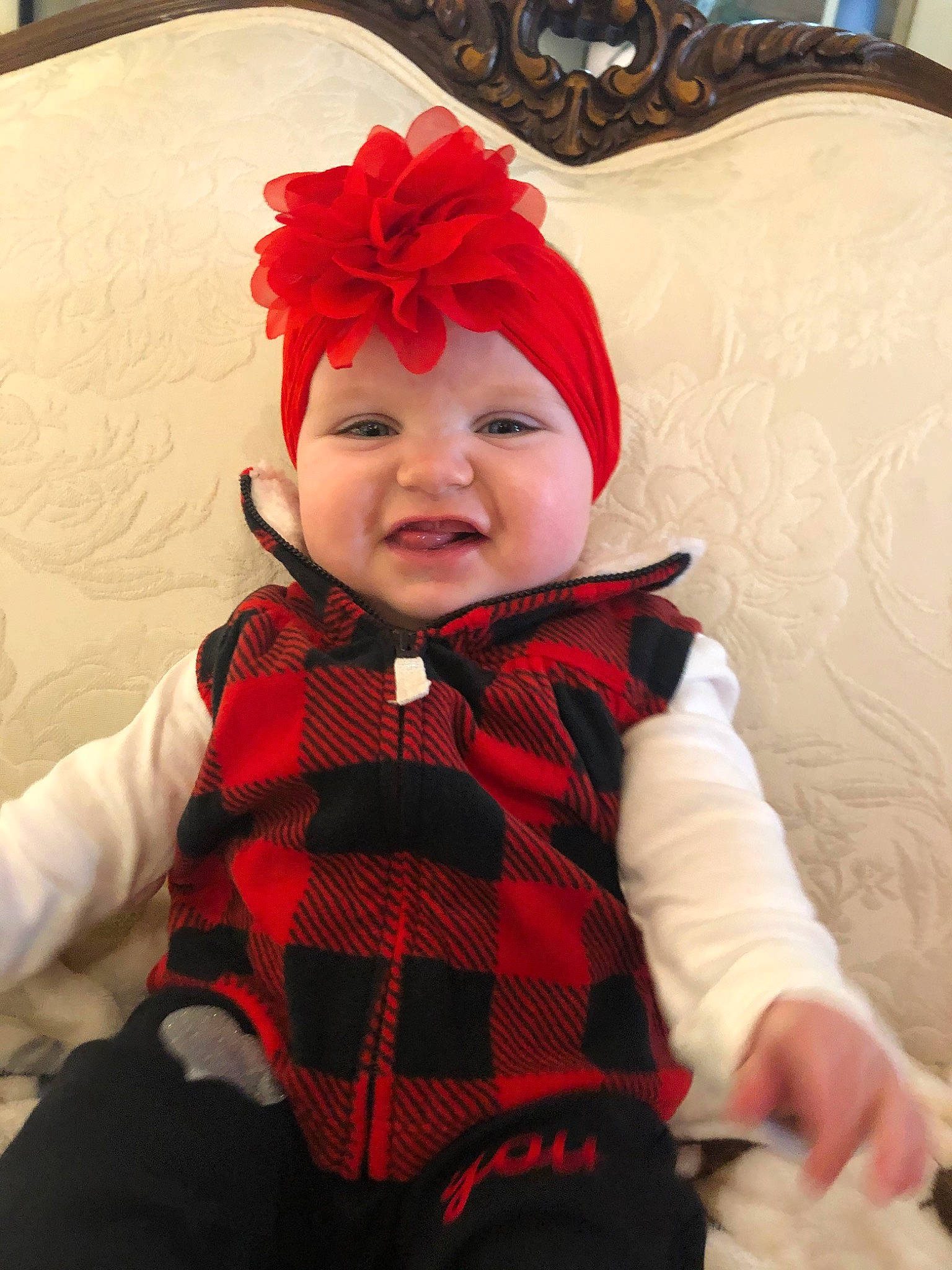Aria joined the competition — help win amazing prizes! baby, baby_products, cheek, child, costume, design, face, fur, hair_accessory, head, headgear, outerwear, pattern, person, plaid, red, smile, tartan, textile, toddler