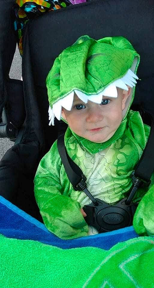 Augustus is registered to the contest to win money with this photo: baby, cap, child, costume_hat, electric_blue, event, eye, fictional_character, fun, goggles, grass, green, hat, head, headwear, holiday, jacket, person, personal_protective_equipment, sleeve