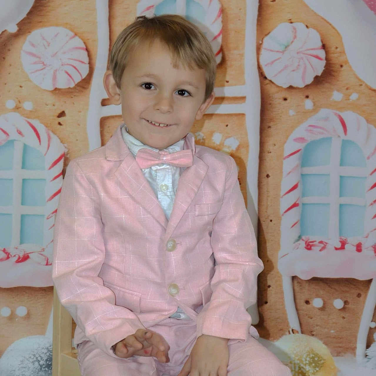 Karsin is registered to the contest to win money with this photo: blazer, boy, child, clothing, coat, face, formalwear, happy, head, indoors, interiordesign, jacket, male, pants, person, photography, portrait, sitting, smile, suit