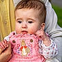 Maisie is registered to the contest to win money with this photo: baby, child, closeup, curly_hair, cute, dress, embroidery, expression, face, family, hand, holding_hand, infant, outdoor, person, peter_rabbit, pink_clothing, portrait, soft_lighting, young_child