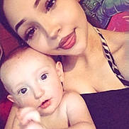 Braxton is registered to the contest to win money with this photo: woman, baby, child, portrait, selfie, indoor, face, smile, skin, person, holding, closeup, young, casual, mural, astronaut, colorful, intimate, family, affection