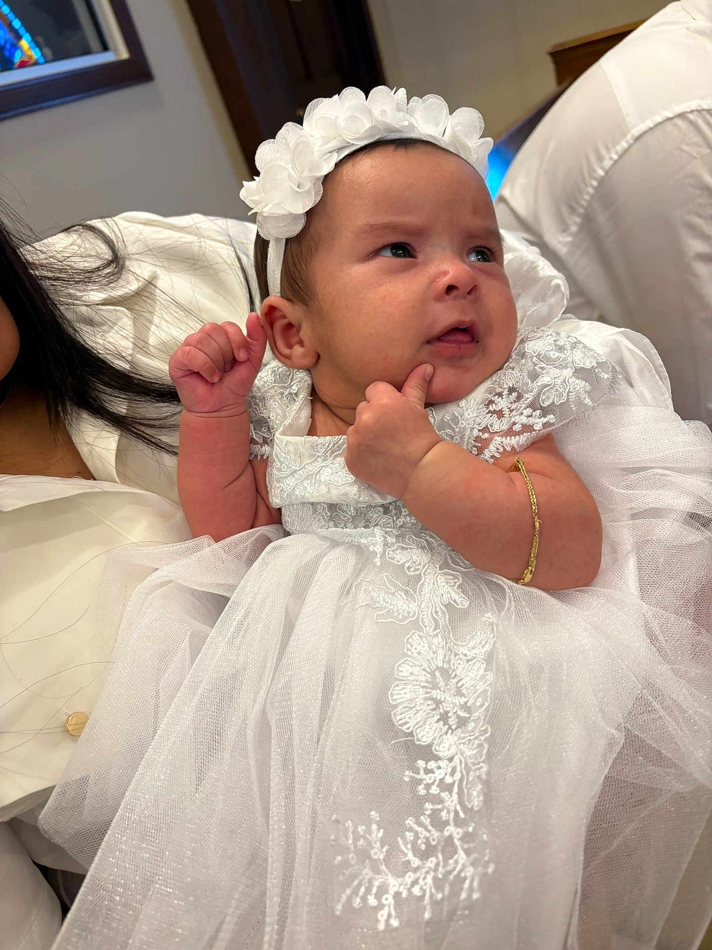 Hannah is registered to the contest to win money with this photo: baby, bracelet, celebration, child, closeup, clothing, cute, expression, face, family, fashion, headband, holding, indoor, infant, lace, person, portrait, soft_light, white_dress