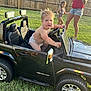 Bryson is registered to the contest to win money with this photo: backyard, casual_clothing, child, diaper, family, fence, fun, grass, happy, outdoor, playing, reflection, running, smile, summer, sunlight, toddler, toy_car, vehicle, woman