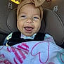 baby, smiling, car_seat, headband, bow, blanket, heart_pattern, child, happy, infant, closeup, face, person, seatbelt, cute, indoors, toddler, apparel, childhood, portrait