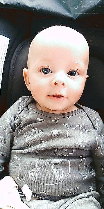 Dennis is registered to the contest to win money with this photo: baby, baby_toddler_clothing, cheek, child, chin, close_up, eye, eyebrow, eyelash, flash_photography, grey, happy, iris, lip, mouth, neck, nose, person, skin, sleeve