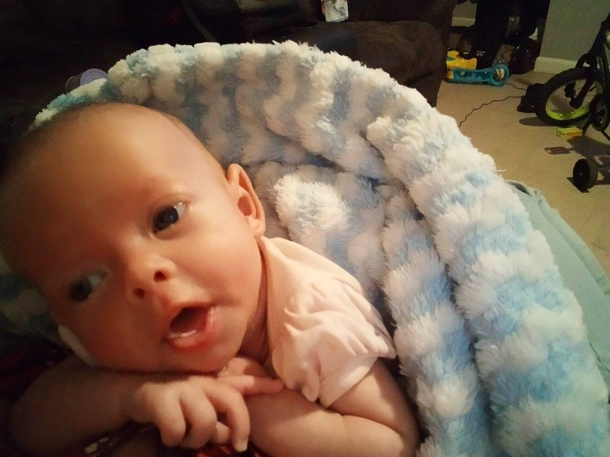 Skylar joined the competition — help win amazing prizes! baby, baby_products, baby_toddler_clothing, cheek, child, comfort, eye, flash_photography, flooring, fur, iris, knitting, linens, nose, person, portrait_photography, room, sitting, skin, toddler
