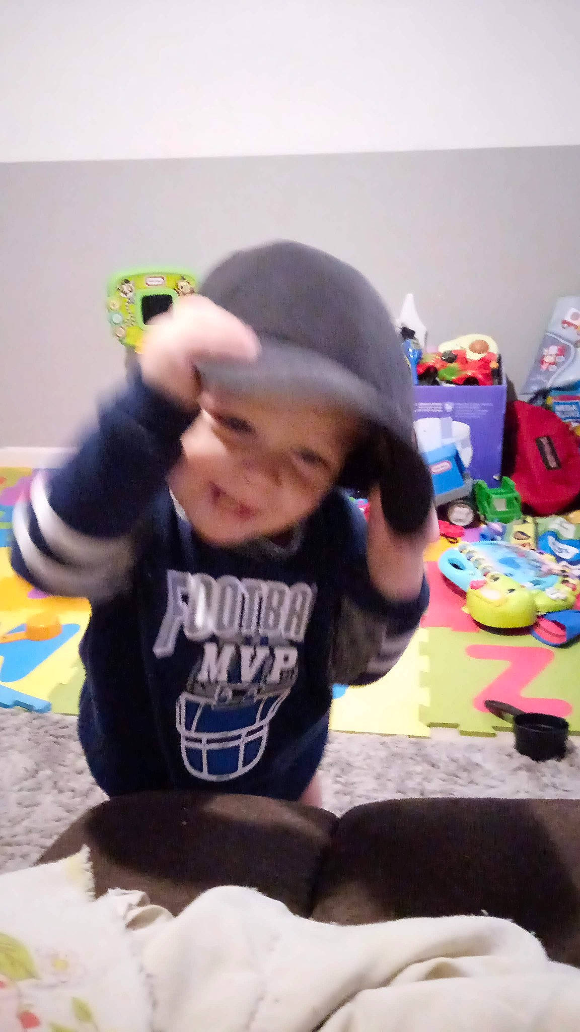 Dennis joined the competition — help win amazing prizes! baby, baby_toddler_clothing, baseball_cap, cap, child, elbow, flooring, fun, happy, headgear, headwear, joy, leisure, person, personal_protective_equipment, play, shorts, sitting, sleeve, smile