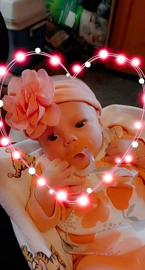 Alivia is registered to the contest to win money with this photo: art, christmas, christmas_decoration, christmas_ornament, event, fictional_character, finger, flower, happy, headwear, holiday, holiday_ornament, interior_design, light, lighting, ornament, party_supply, peach, person, petal