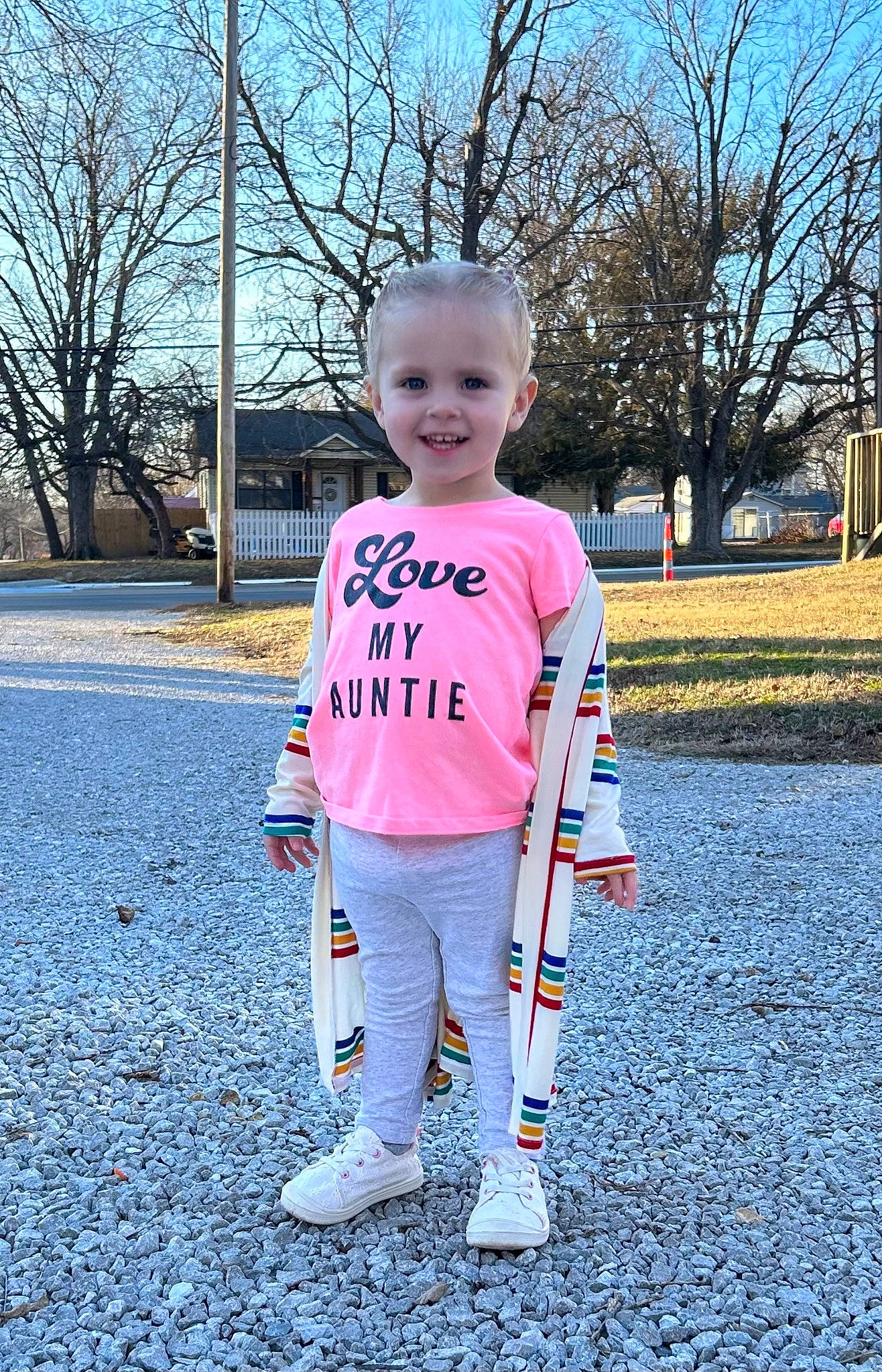 Bexley is registered to the contest to win money with this photo: asphalt, baby_toddler_clothing, electric_blue, fun, grass, happy, head, joy, leisure, magenta, pattern, people_in_nature, person, plant, recreation, sky, sleeve, smile, standing, t_shirt