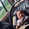 baby, car_seat, child, infant, smiling, seatbelt, vehicle_interior, window, greenery, safety, happy, portrait, person, young_child, clothing, car, seat, cute, infant_care, travel