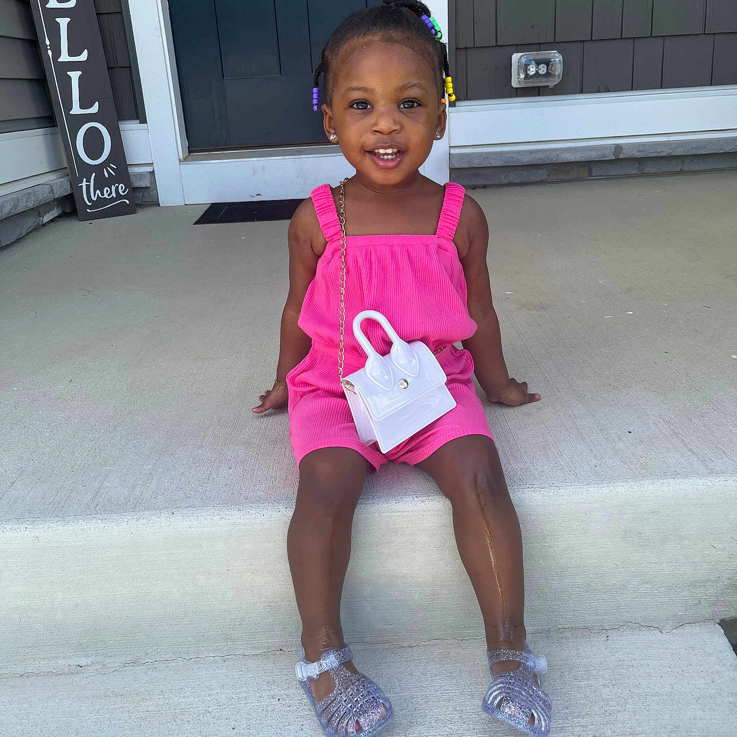 Niyanna is registered to the contest to win money with this photo: ball, child, clothing, door, face, female, football, footwear, girl, head, person, photography, portrait, sandal, shoe, shorts, sitting, soccer, soccerball, sport