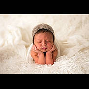 Bronson joined the competition — help win amazing prizes! newborn, baby, sleeping, infant, hat, blanket, soft, cute, hands, chin, cozy, portrait, closeup, peaceful, resting, white, fur, skin, headwear, child