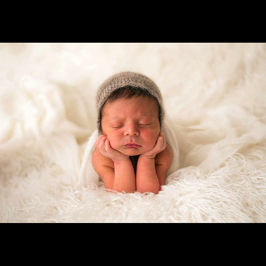 Bronson joined the competition — help win amazing prizes! baby, blanket, child, chin, closeup, cozy, cute, fur, hands, hat, headwear, infant, newborn, peaceful, portrait, resting, skin, sleeping, soft, white