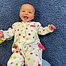 baby, smiling, polka_dot, onesie, infant, lying_down, carpet, blue, happy, child, cute, playful, toddler, indoors, clothing, person, face, joy, colorful, soft_texture