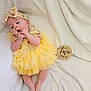baby, infant, two_months, yellow_dress, headband, blanket, lying_down, feet, hands, wooden_milestone, milestone, tulle_skirt, tutu, open_mouth, cute, adorable, portrait, soft_texture, props, newborn