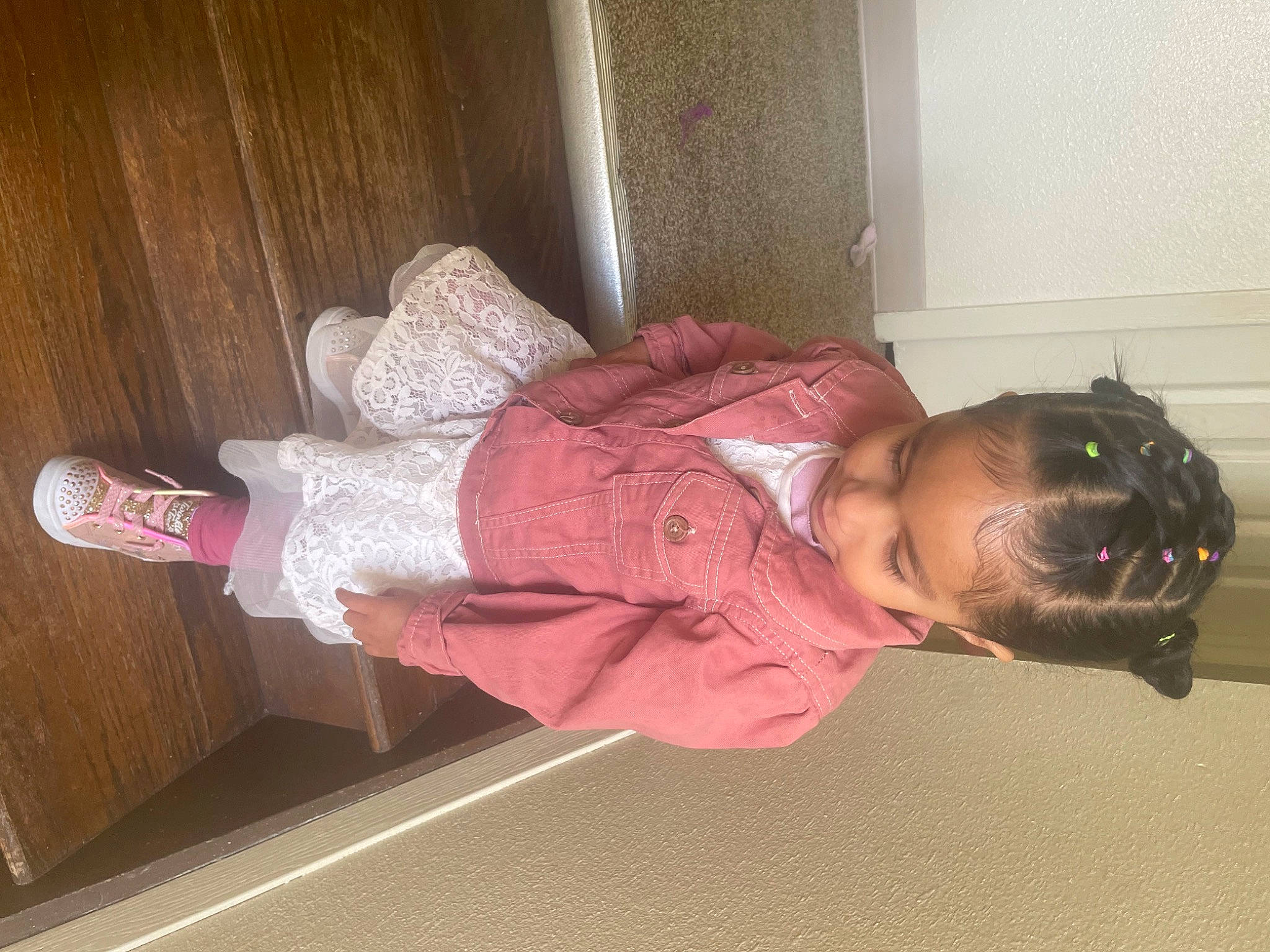 Ofelia is registered to the contest to win money with this photo: arm, baby_toddler_clothing, child, comfort, dress, elbow, floor, flooring, fun, hardwood, human_leg, knee, magenta, person, room, sitting, sock, sunglasses, thigh, toddler