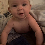 Layla is registered to the contest to win money with this photo: baby, infant, child, blanket, bedding, bedroom, wallpaper, portrait, closeup, eyes, cheeks, hands, crawling, looking_at_camera, indoor, towel, skin, cute, smile, home