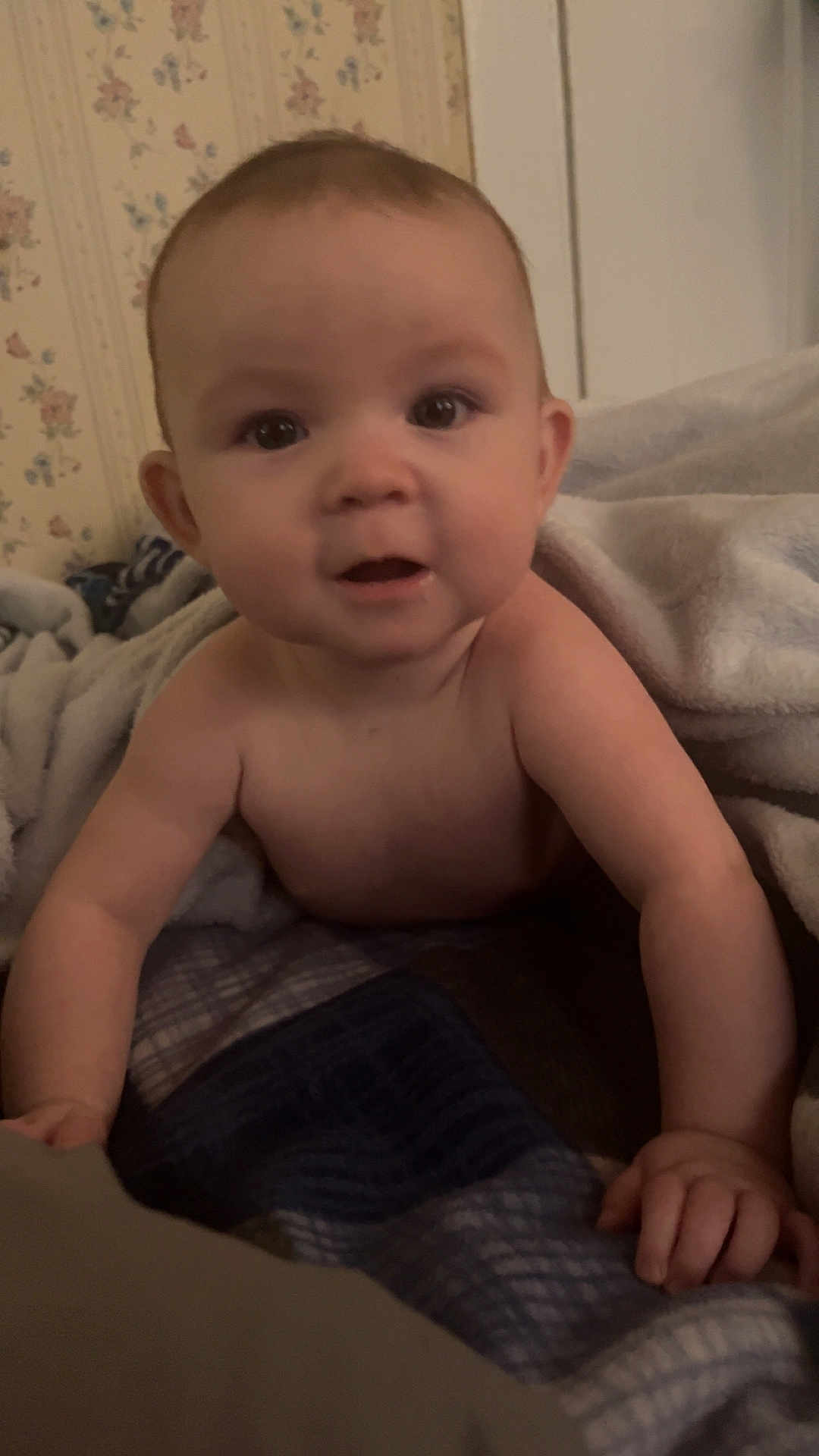 Layla is registered to the contest to win money with this photo: baby, infant, child, blanket, bedding, bedroom, wallpaper, portrait, closeup, eyes, cheeks, hands, crawling, looking_at_camera, indoor, towel, skin, cute, smile, home