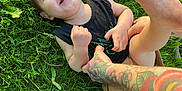 Kuiper joined the competition — help win amazing prizes! baby, bodypart, clothing, face, footwear, grass, head, lawn, nature, outdoors, park, person, photography, plant, portrait, shoe, shorts, skin, summer, tattoo