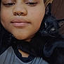 Stinky Binky joined the competition — help win amazing prizes! affection, animal, black_cat, bonnet, casual_clothing, cat, close_up, companionship, face, feline, headwear, hug, human, indoor, nose_ring, person, pet, portrait, relaxed, snuggle