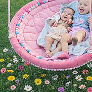 Jewels is registered to the contest to win money with this photo: child, baby, toddler, swing, pink_swing, outdoor, grass, flowers, smiling, happy, playful, joyful, blanket, cute, nature, summer, fun, garden, siblings, relaxing