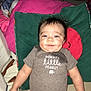 Monsai is registered to the contest to win money with this photo: baby, bed, bedroom, clothing, couch, cushion, face, furniture, happy, head, homedecor, indoors, person, photography, pillow, portrait, room, shorts, smile, t_shirt