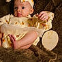 baby, infant, child, headband, pumpkin_print, dress, tulle_skirt, foot, hand, face, eyes, blanket, fur_texture, wooden_sign, milestone, two_months, portrait, indoor, soft_lighting, cute