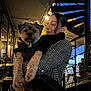 Pilou participe au concours pour gagner de l'argent avec cette photo : woman, dog, pet, holding, houndstooth_coat, black_jacket, spiral_staircase, evening, urban, outdoor, railing, black_purse, metal, person, street, architecture, casual, portrait, cute, warm_clothing