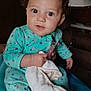 baby, blanket, child, clothing, comfort, cozy, curly_hair, cute, expression, face, furniture, hands, holding, indoors, infant, lamp, onesie, portrait, seated, young_child