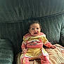 baby, child, smiling, sitting, couch, clothing, happy, infant, person, indoors, cute, pattern, fabric, foot, hand, face, home, portrait, cozy, colorful