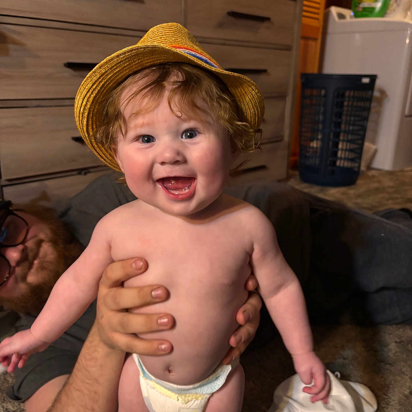 Damian joined the competition — help win amazing prizes! accessories, baby, bodypart, bonnet, clothing, couch, diaper, face, finger, furniture, glasses, hand, hat, head, person, photography, portrait, shorts, sunhat, wood