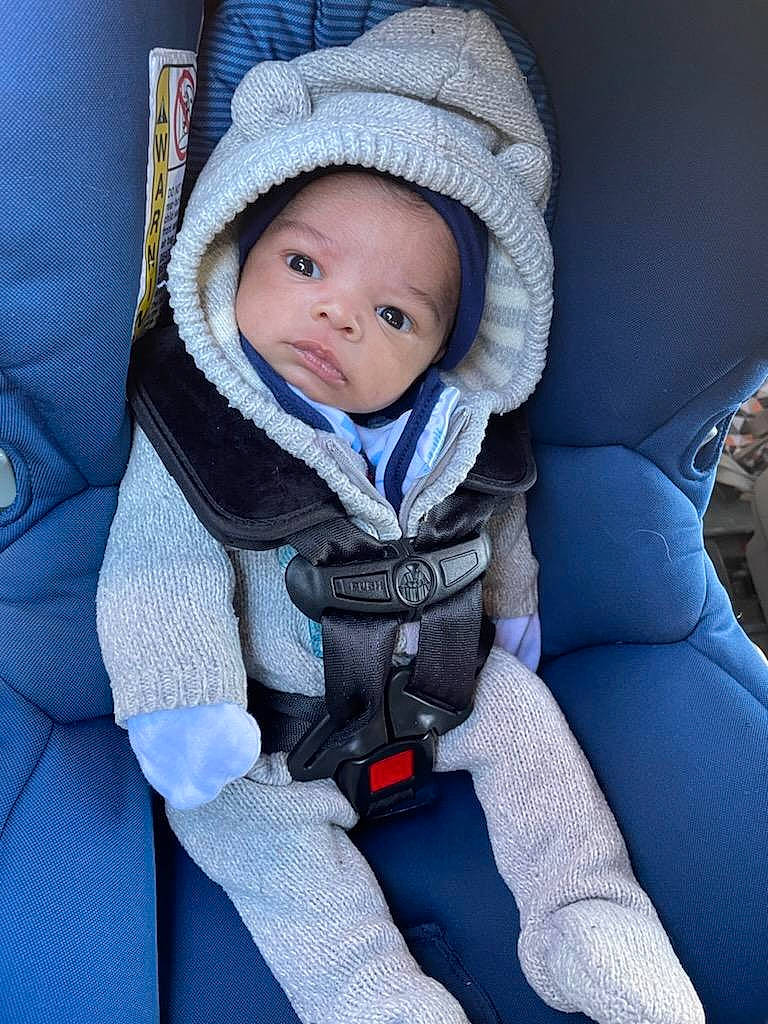 Dean is registered to the contest to win money with this photo: auto_part, baby, baby_carriage, baby_products, baby_safety, baby_toddler_clothing, cap, car_seat, car_seat_cover, cheek, child, comfort, electric_blue, fashion_accessory, head_restraint, person, personal_protective_equipment, seat_belt, sitting, toddler