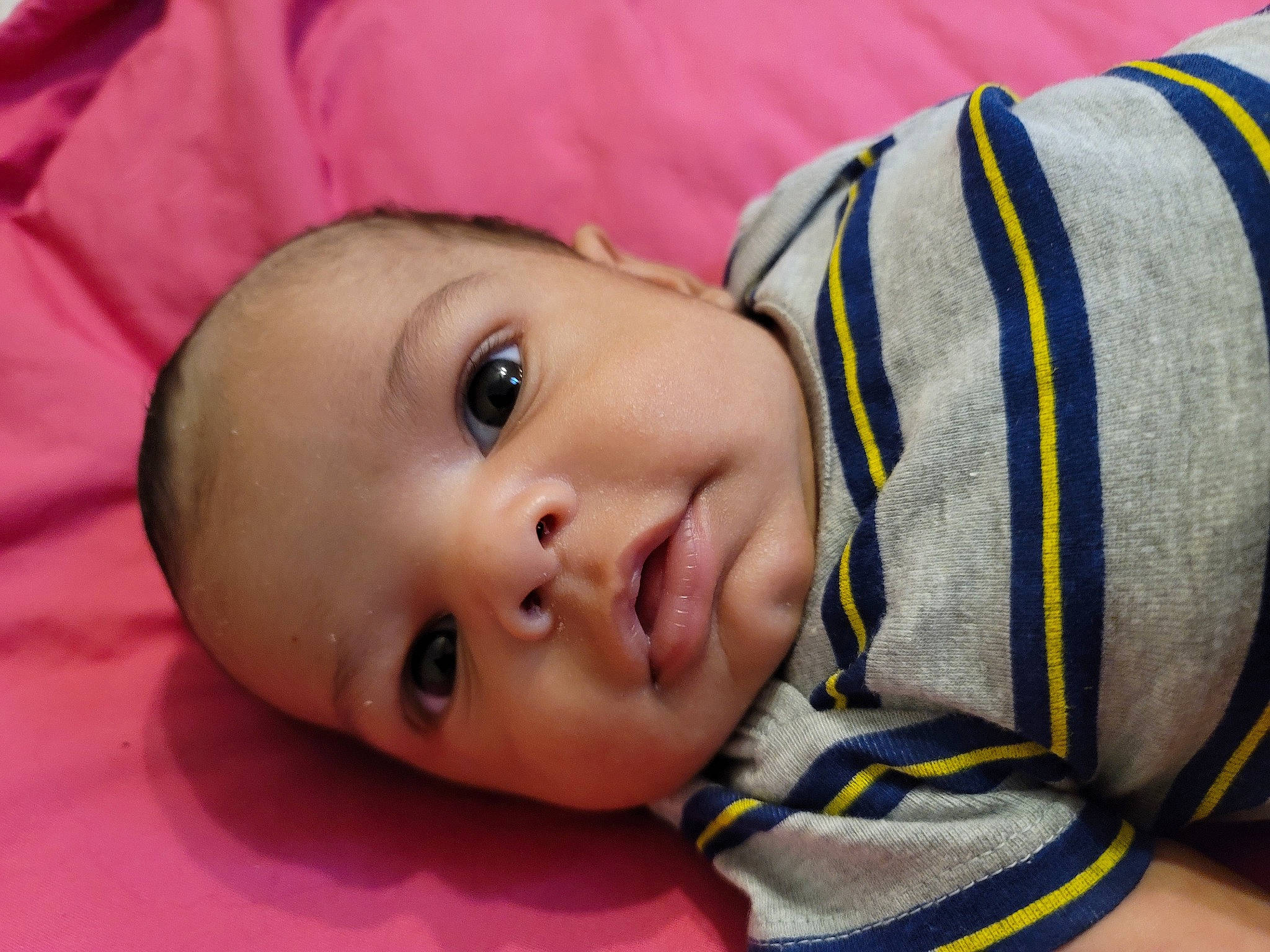 Dean is registered to the contest to win money with this photo: baby, baby_toddler_clothing, cheek, child, close_up, comfort, eyebrow, eyelash, grass, happy, human_body, iris, linens, lip, mouth, nose, outerwear, person, skin, textile