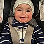 baby, child, car_seat, smile, striped_clothing, hat, infant, face, cute, safety_harness, closeup, adorable, cheeks, young_child, seatbelt, portrait, one_person, clothing, indoors, happy