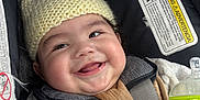 Ryan joined the competition — help win amazing prizes! baby, blanket, car_seat, child, clothing, comfort, cute, face, hand, happy, indoors, infant, knit_hat, milk_bottle, person, portrait, seatbelt, smiling, soft, warm