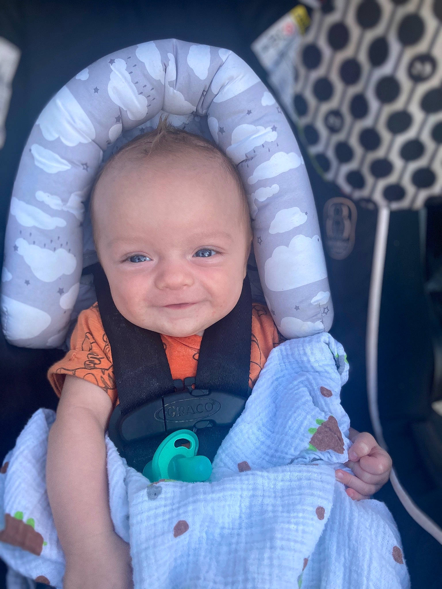 Atticus is registered to the contest to win money with this photo: azure, baby, baby_carriage, baby_toddler_clothing, cheek, comfort, electric_blue, eye, finger, happy, head, iris, nose, person, product, purple, skin, sleeve, smile, textile