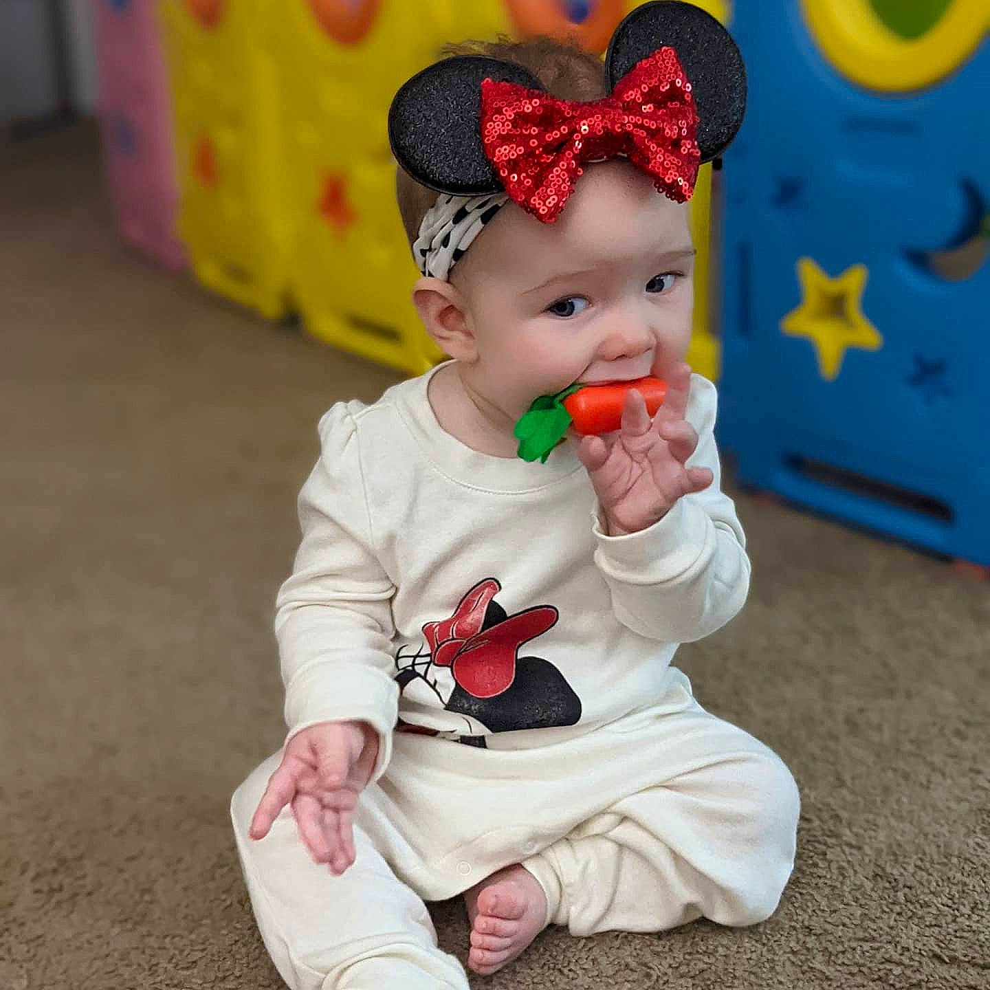 Cassandra joined the competition — help win amazing prizes! baby, baby_playing_with_toys, baby_toddler_clothing, beanie, cap, cheek, child, fashion_accessory, fun, grass, happy, headwear, human_body, leisure, magenta, pattern, person, pink, play, sitting