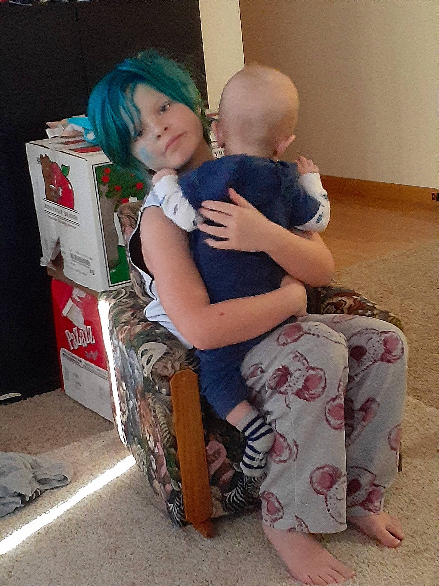 Skye is registered to the contest to win money with this photo: baby, bag, barefoot, child, comfort, event, floor, flooring, foot, fun, happy, human_leg, joint, knee, lap, luggage_and_bags, person, sitting, t_shirt, thigh