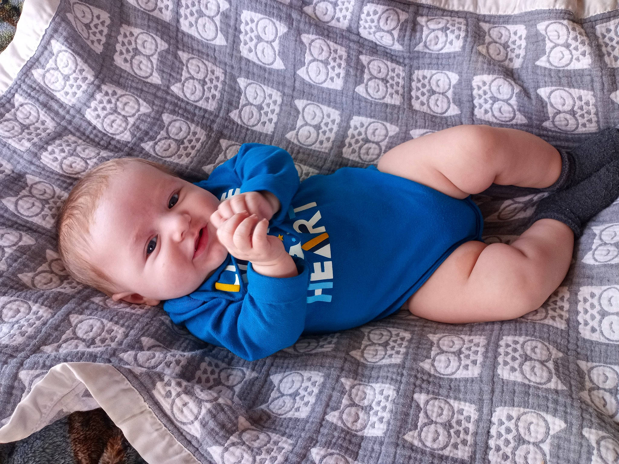 Caspian joined the competition — help win amazing prizes! baby, baby_toddler_clothing, child, comfort, electric_blue, eye, foot, head, headgear, human_leg, knee, leg, linens, pattern, person, sitting, skin, smile, thigh, toddler